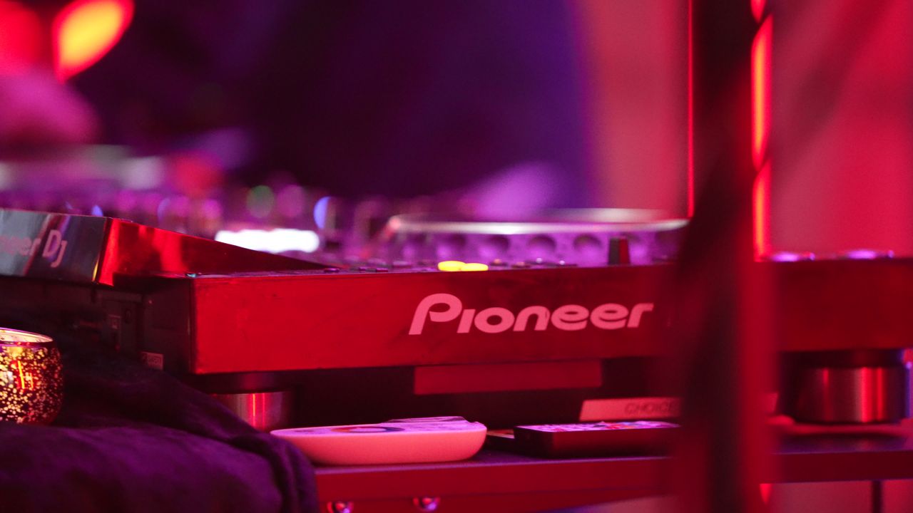 Pioneer DJ decks glowing under red light