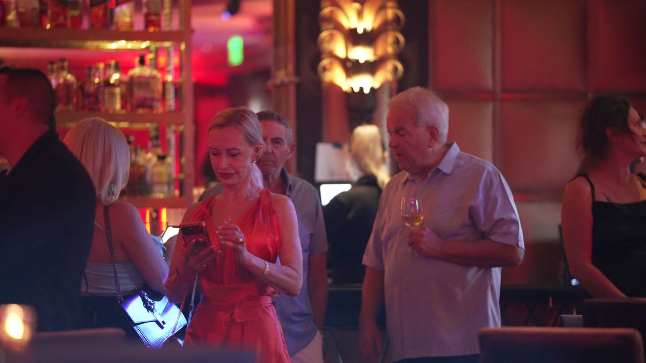 Guests in conversation at the bar