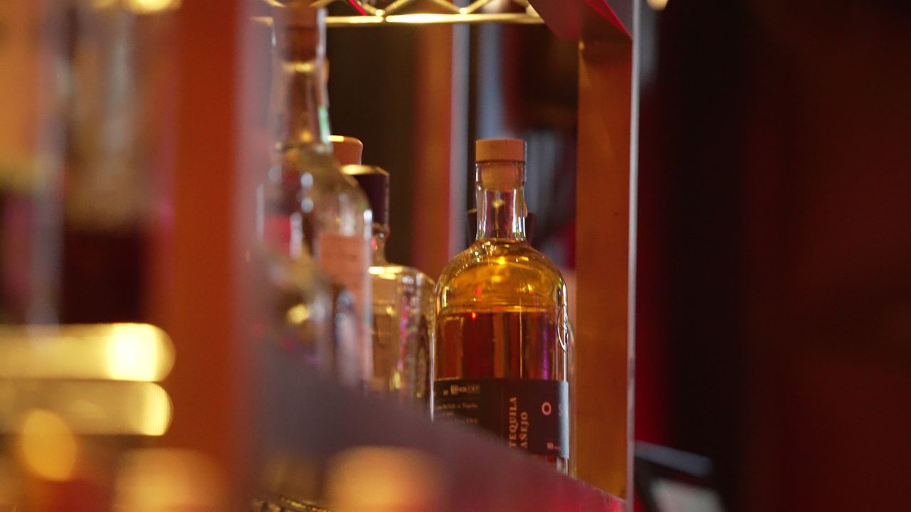Bottles on the back bar in warm light