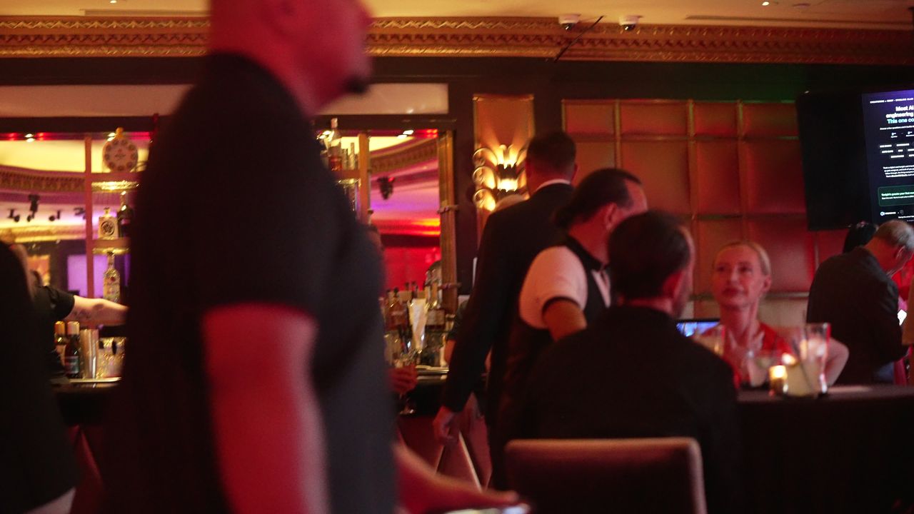 Guests gathered at high-top tables near the bar