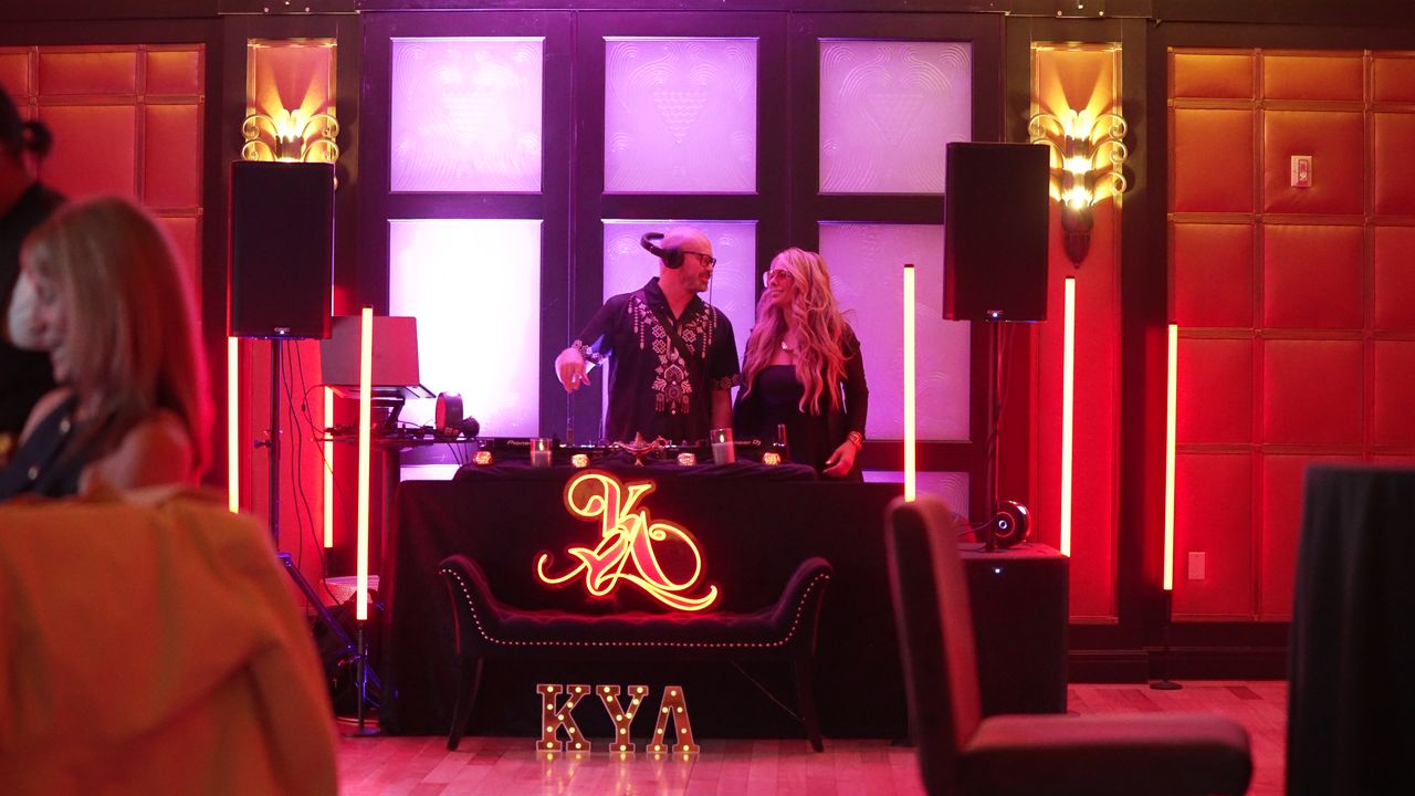 Wide view of the KYA KLUB DJ booth with two DJs at the decks