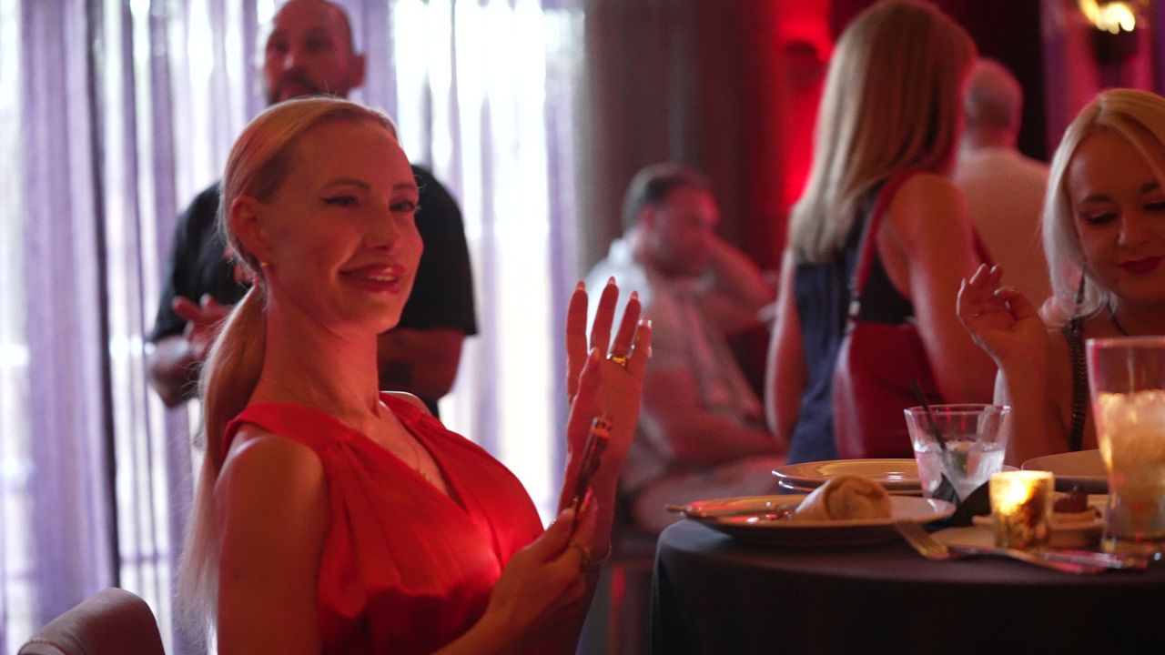 A guest smiling at a dinner table