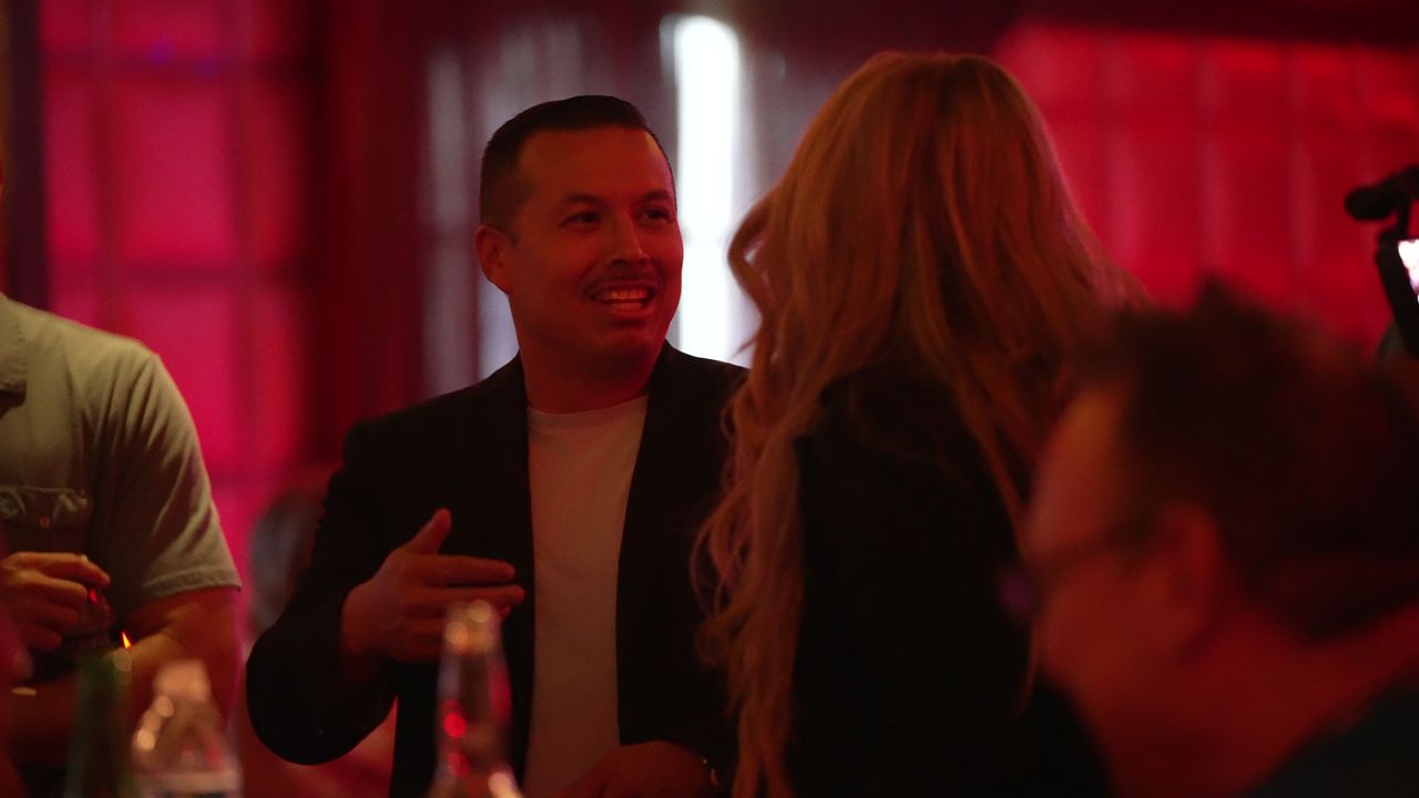 A guest laughing in the crowd
